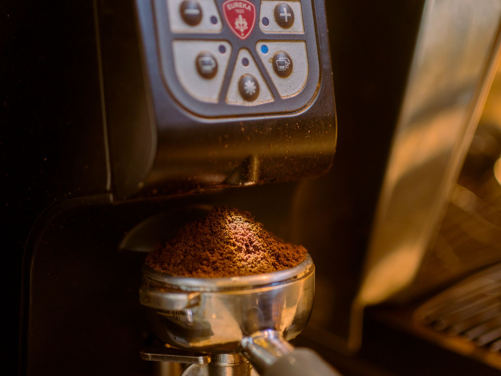 Coffee beans being ground into fresh grounds
