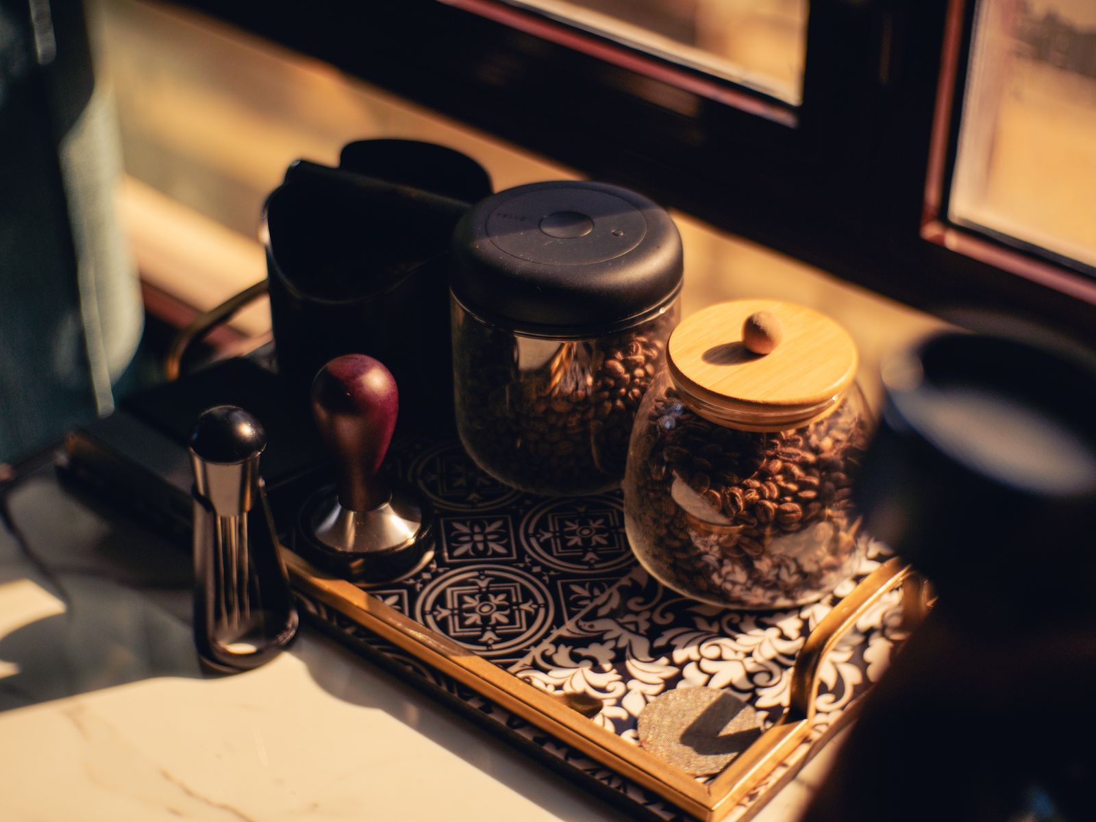 Coffee storage jars kept on a tray in a cool dark corner
