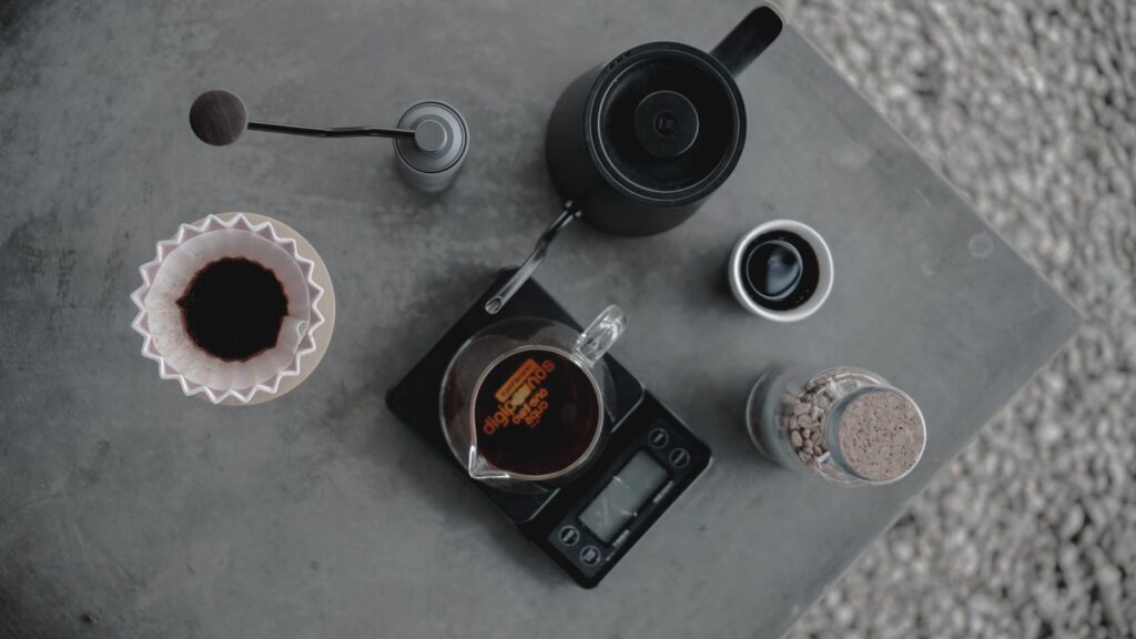 Coffee brewing setup with pour-over, grinder and scale for measuring the coffee-to-water ratio