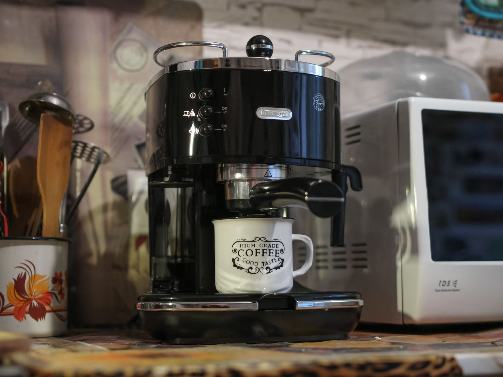 A compact budget coffee maker brewing in a small kitchen