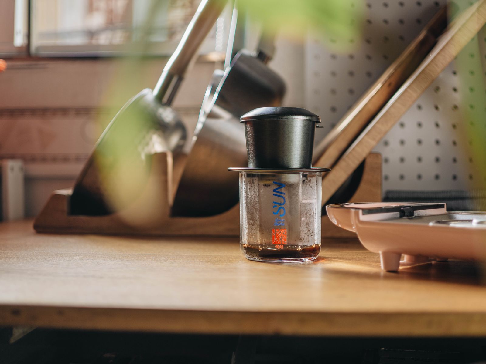 Coffee maker and tools arranged on a small kitchen counter