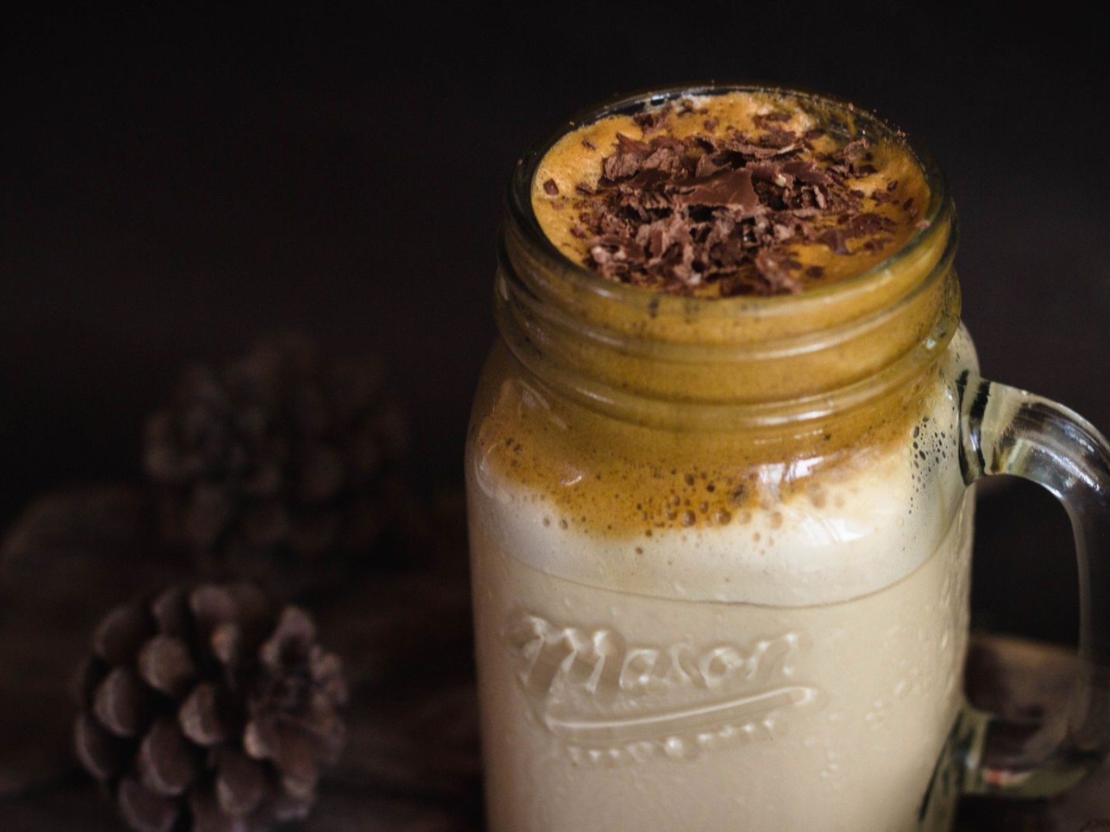 Creamy dalgona coffee topped with chocolate shavings in a mason jar