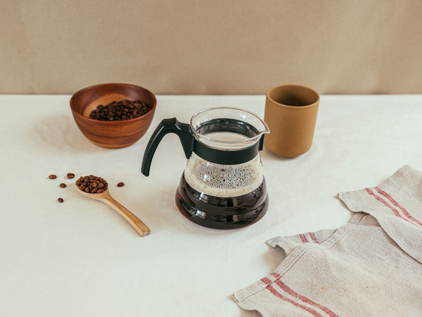 A drip coffee maker with beans and a pot, ready for these drip coffee maker tips