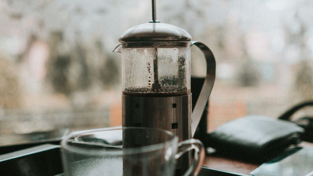 French press coffee with a glass cup on a tray
