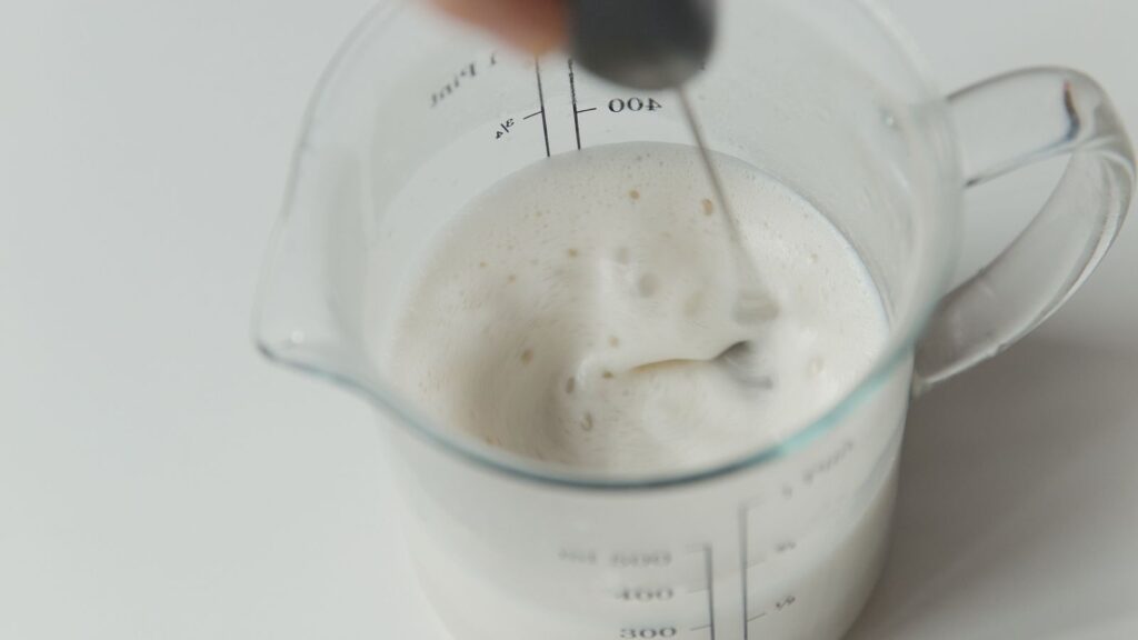 Hand frothing milk in a jar without an espresso machine