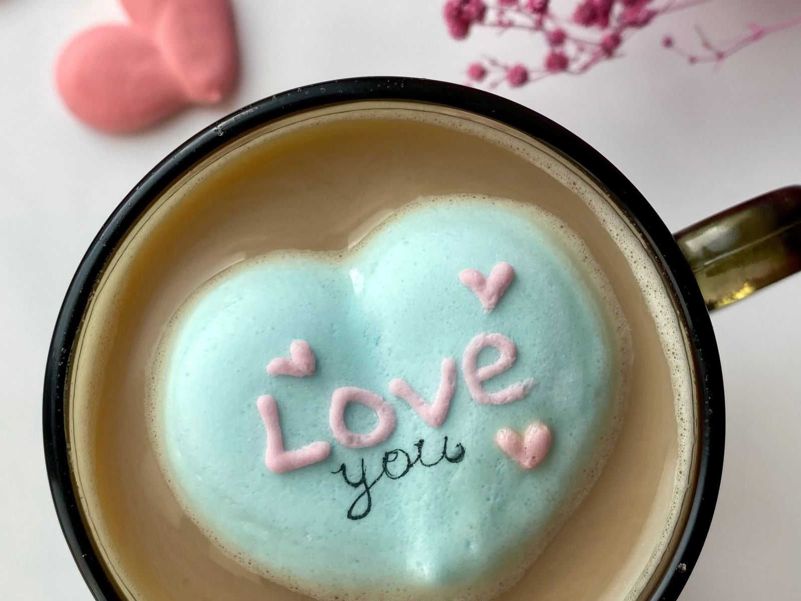 Cup of coffee with heart-shaped foam art on top
