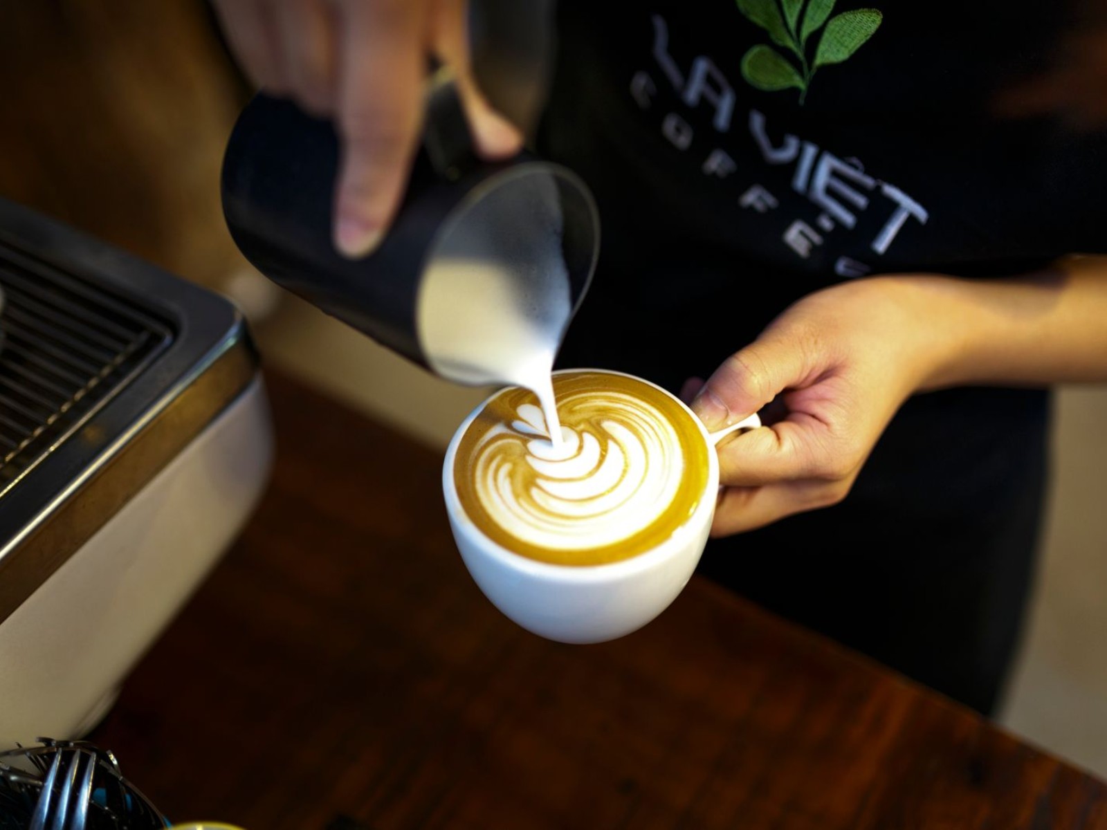 A finished cappuccino with intricate latte art
