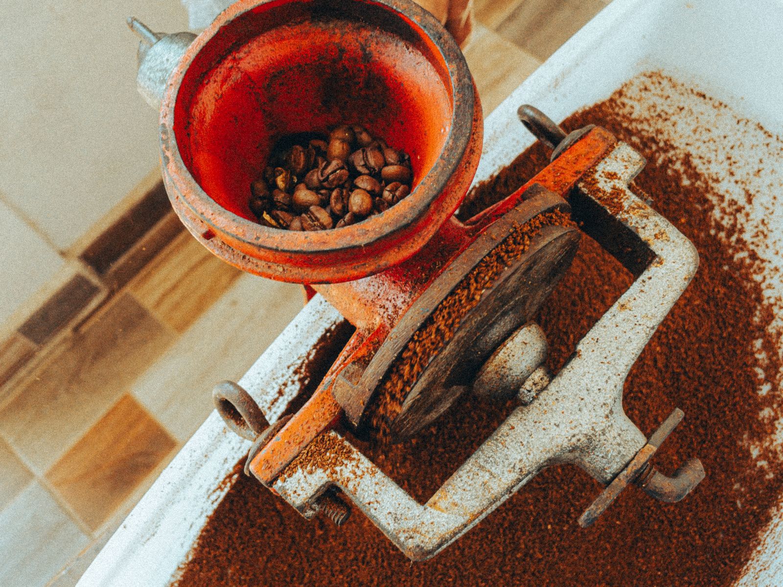 Rustic manual coffee grinder with fresh coffee grounds