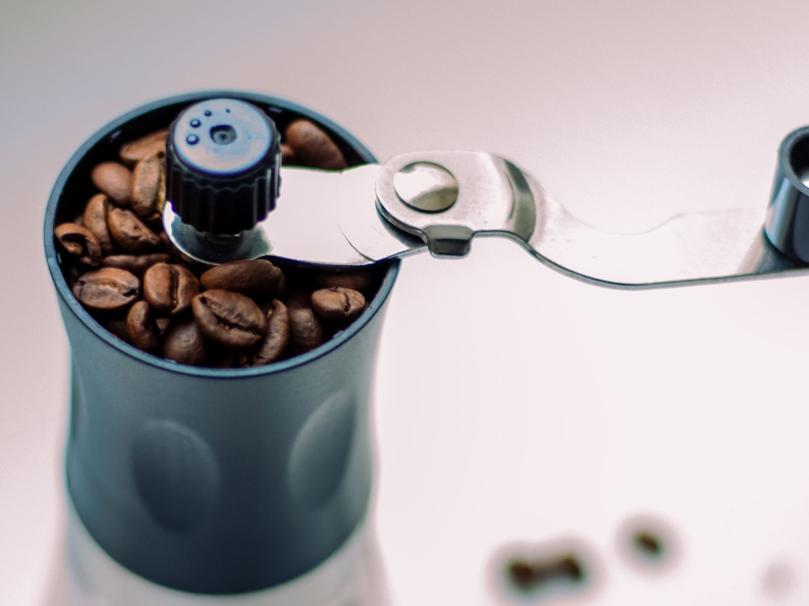 Manual coffee grinder filled with whole beans