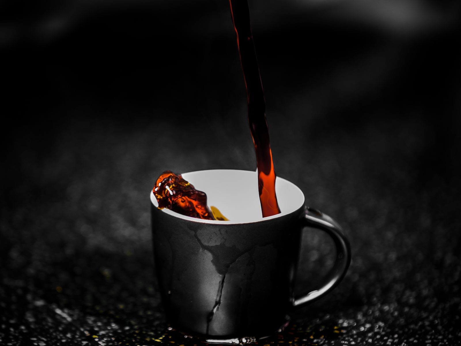 Freshly brewed coffee being poured into a cup at home