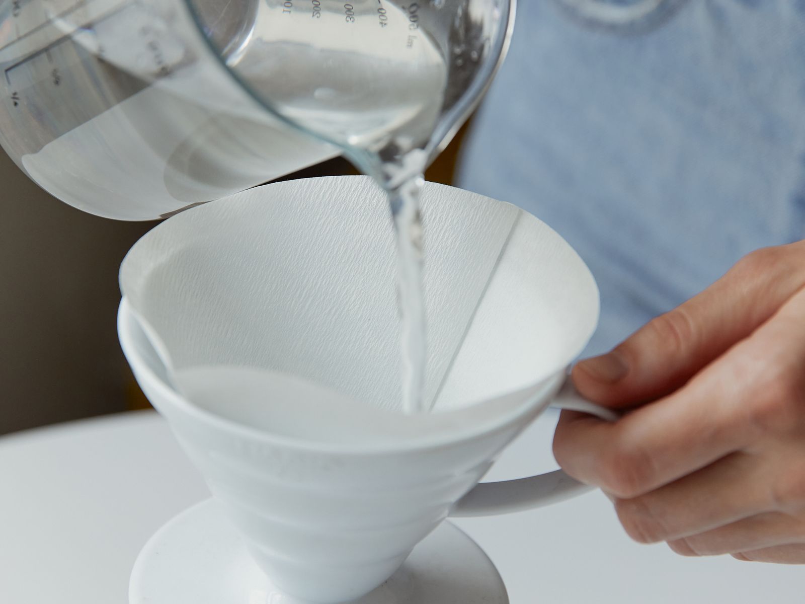 Pouring hot water in slow circles into a coffee dripper filter