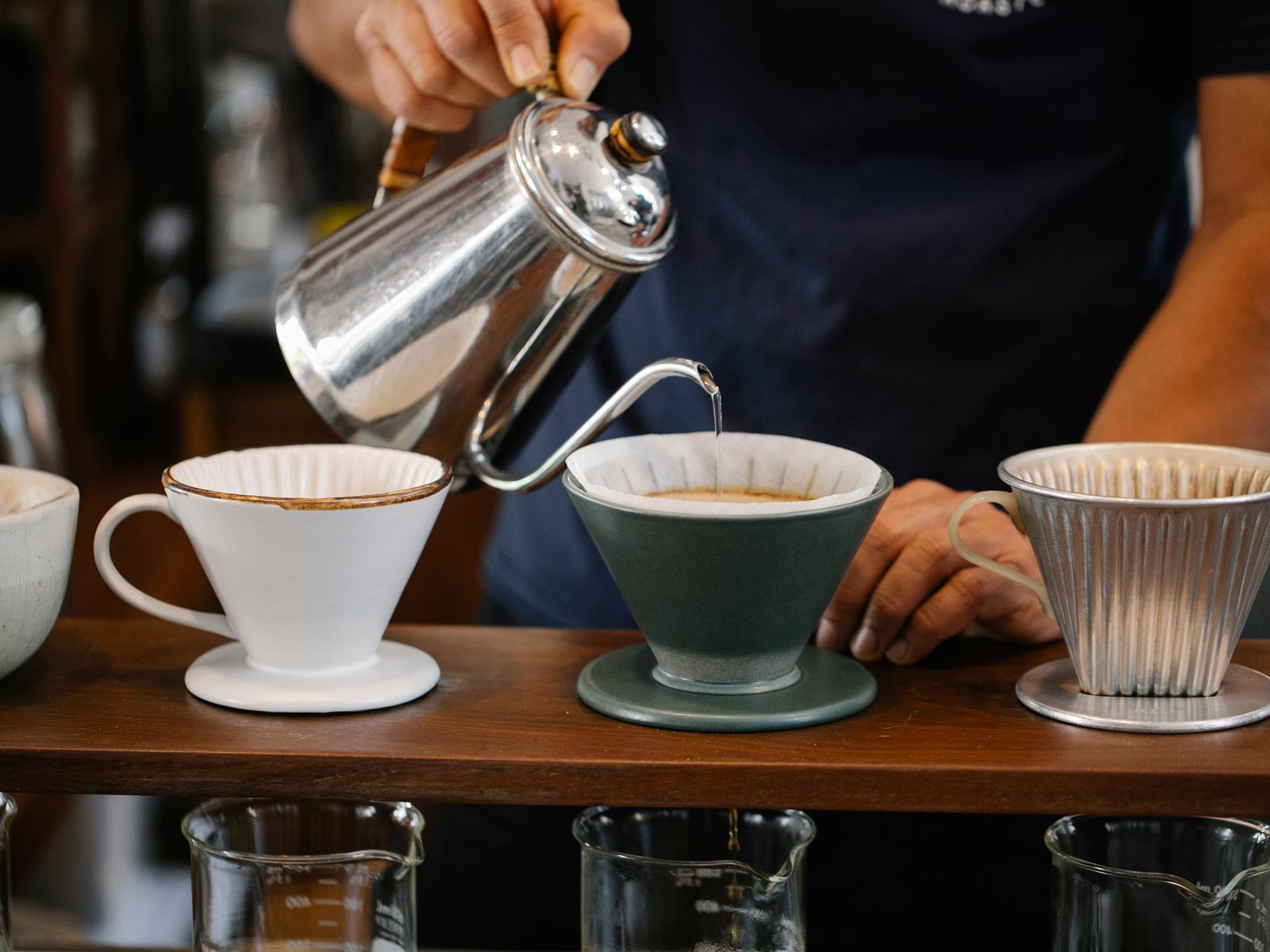 Pouring hot water from a gooseneck kettle into a pour-over dripper