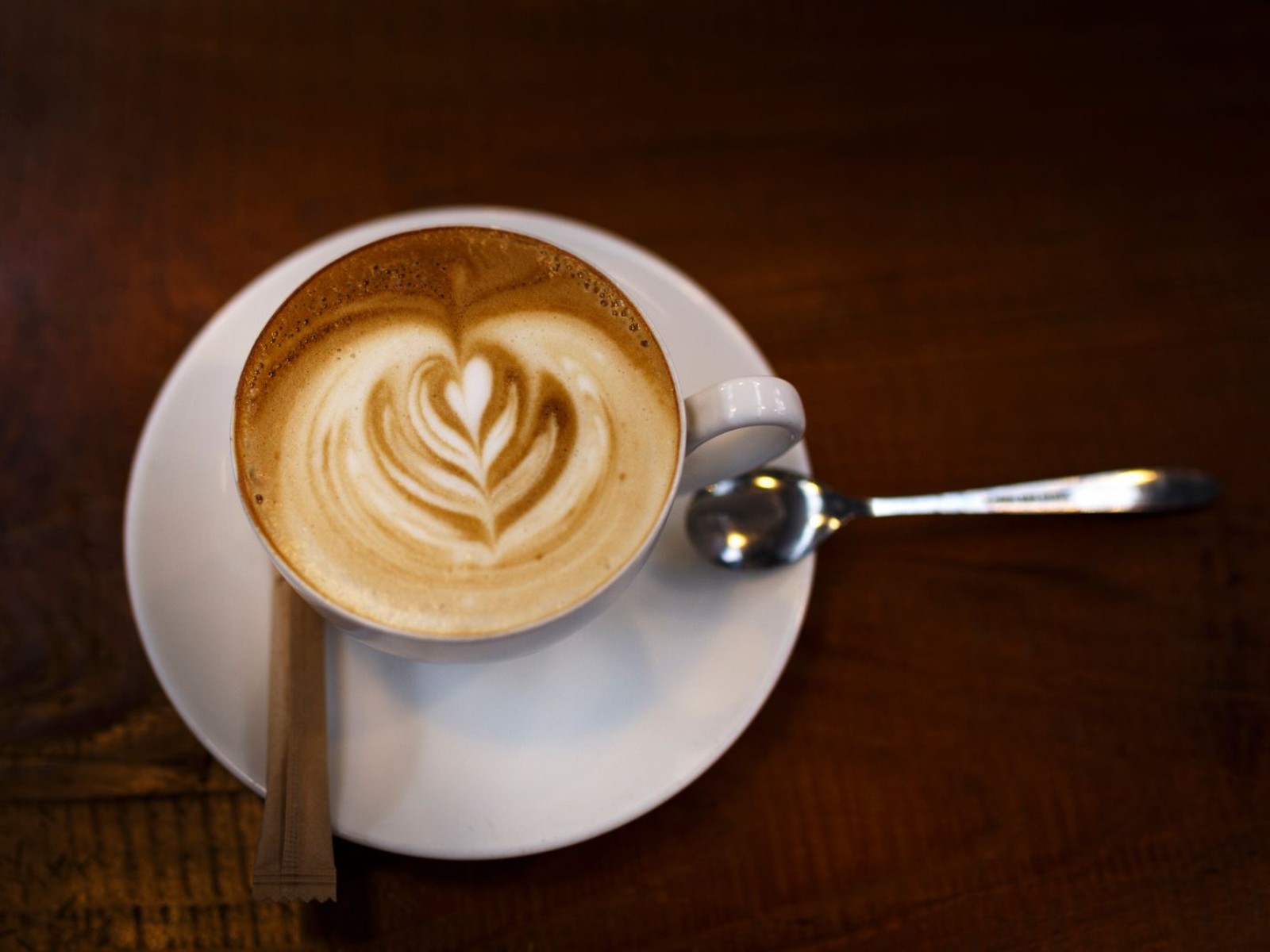 Silky steamed milk microfoam poured into coffee