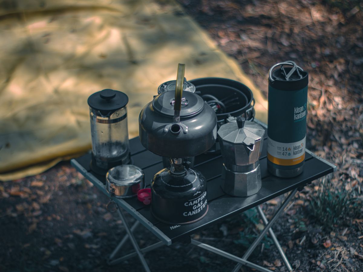 A cozy camping setup with coffee-making gear