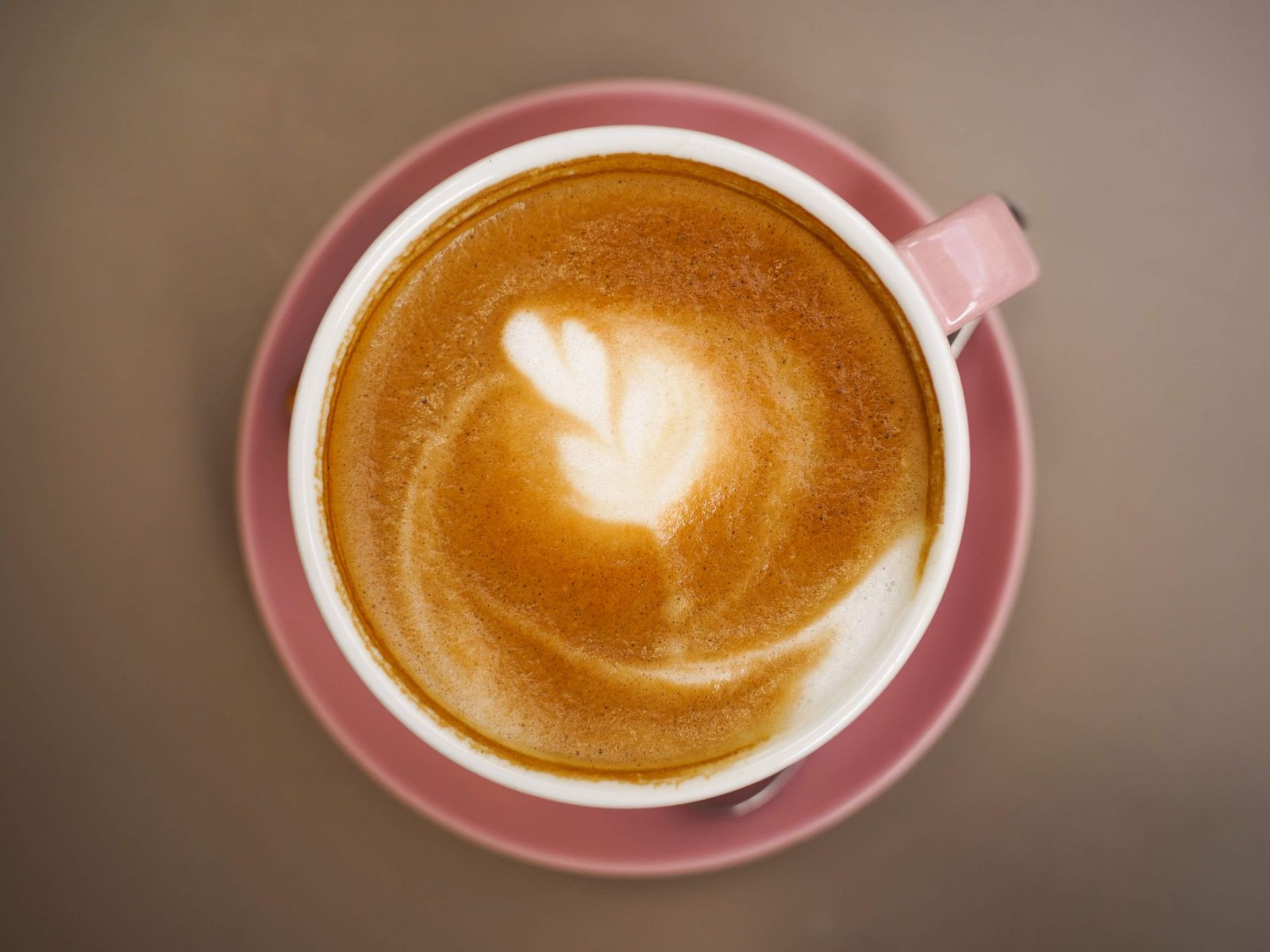 A cappuccino with a thick foam cap seen from above