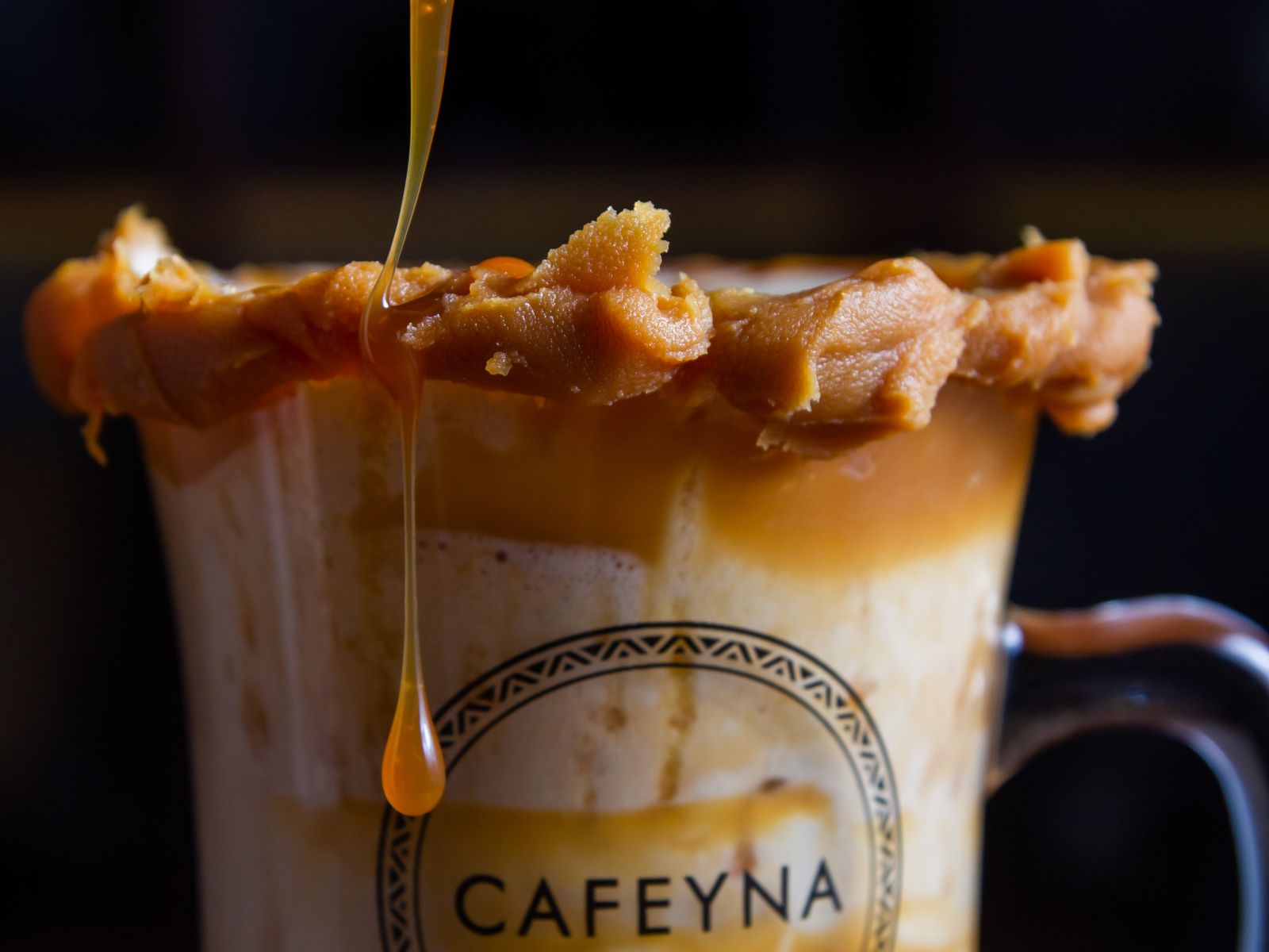 Homemade caramel syrup drizzled into a cold coffee drink