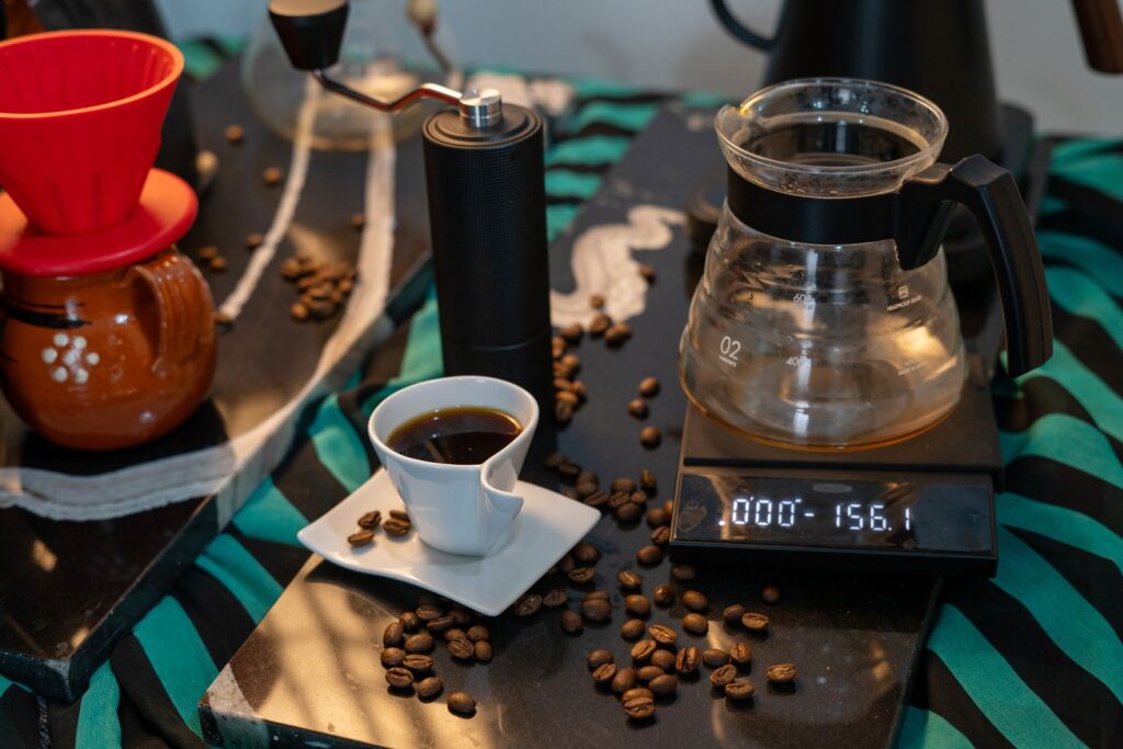 A budget coffee brewing setup with a hand grinder, scale and dripper for cheap coffee upgrades