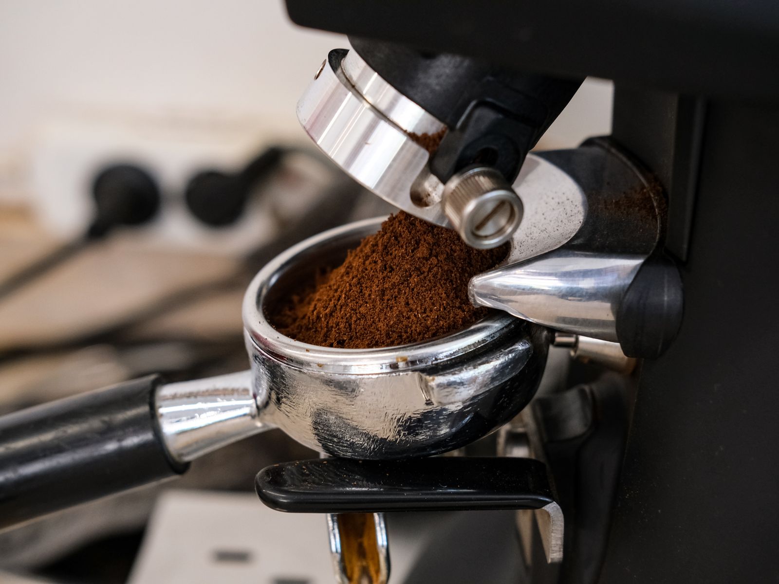 Checking grind size during pour-over troubleshooting to fix bitter or sour coffee