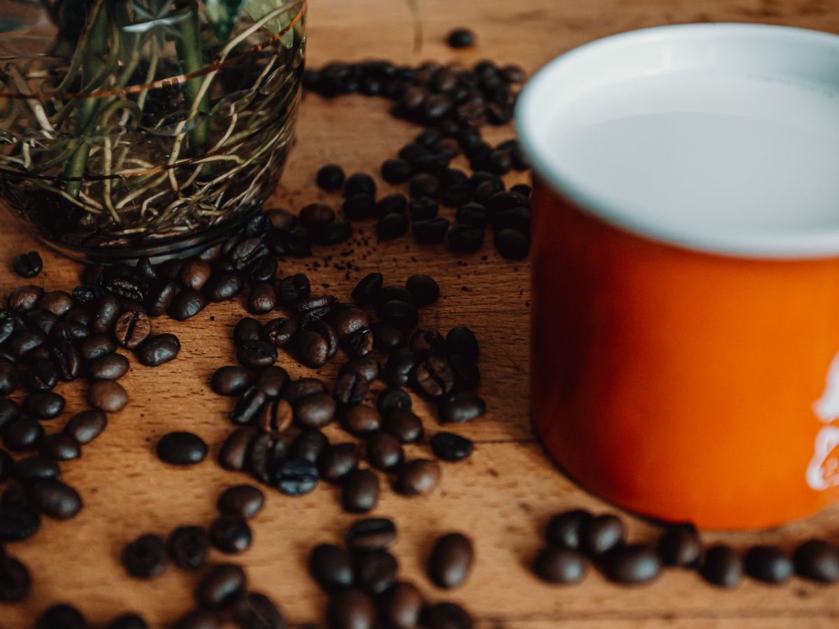 Freshly roasted coffee beans scattered on a wooden table