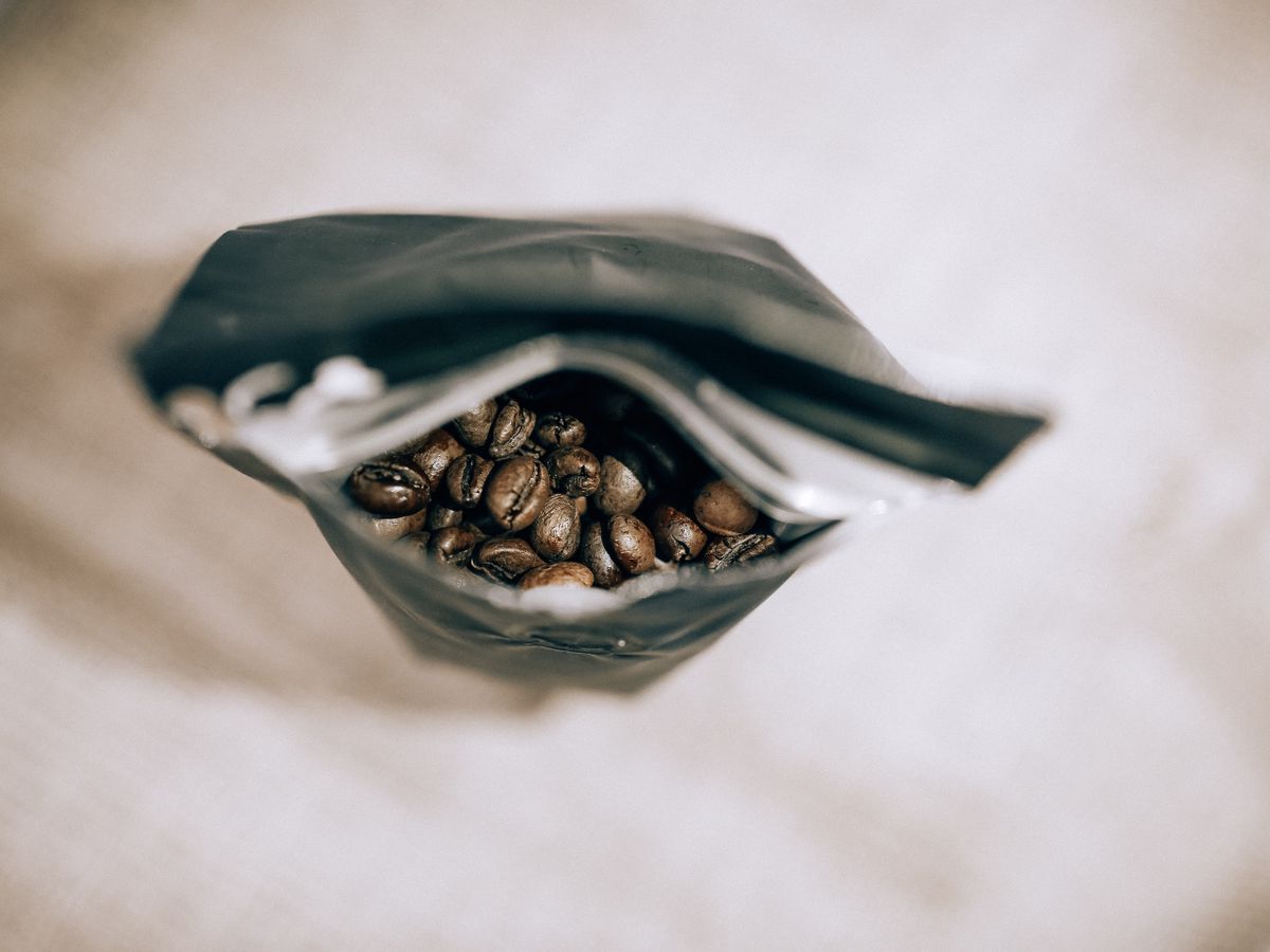 Top view of an open bag revealing fresh roasted coffee beans