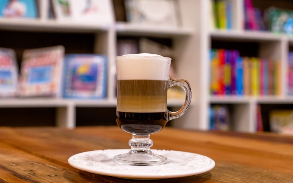Homemade mocha with layered coffee, chocolate and milk in a glass mug