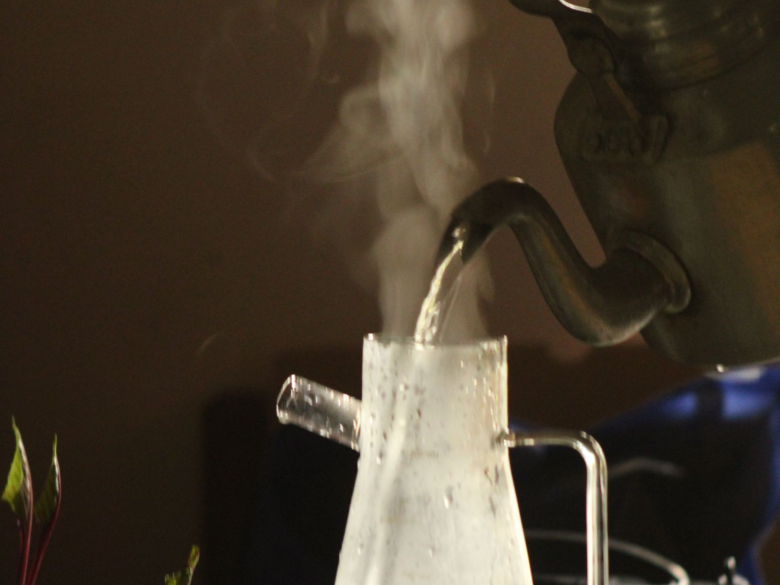 Steaming kettle pouring water at the right temperature for pour-over coffee