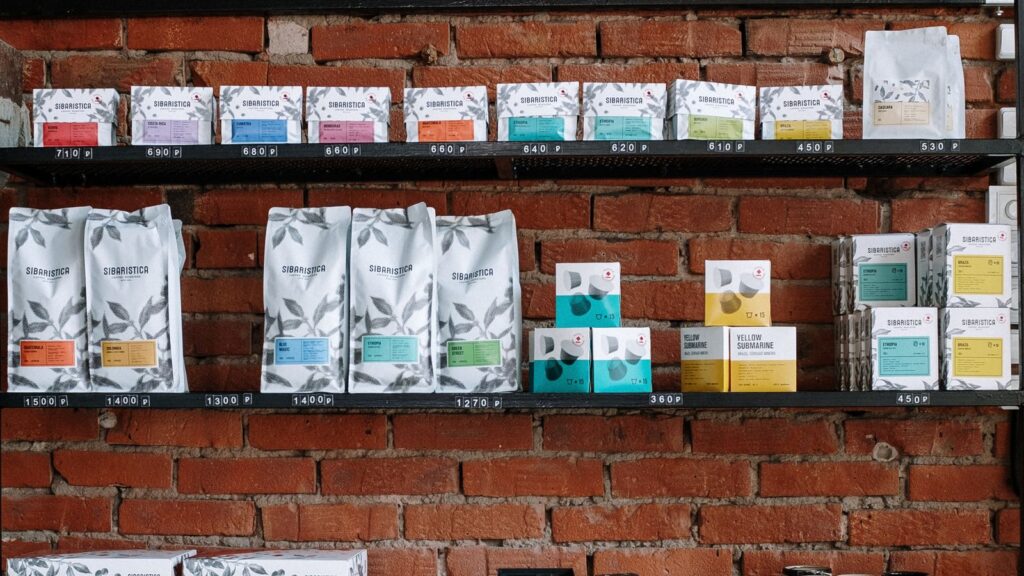 Specialty coffee bags lined up on a shop shelf ready to choose
