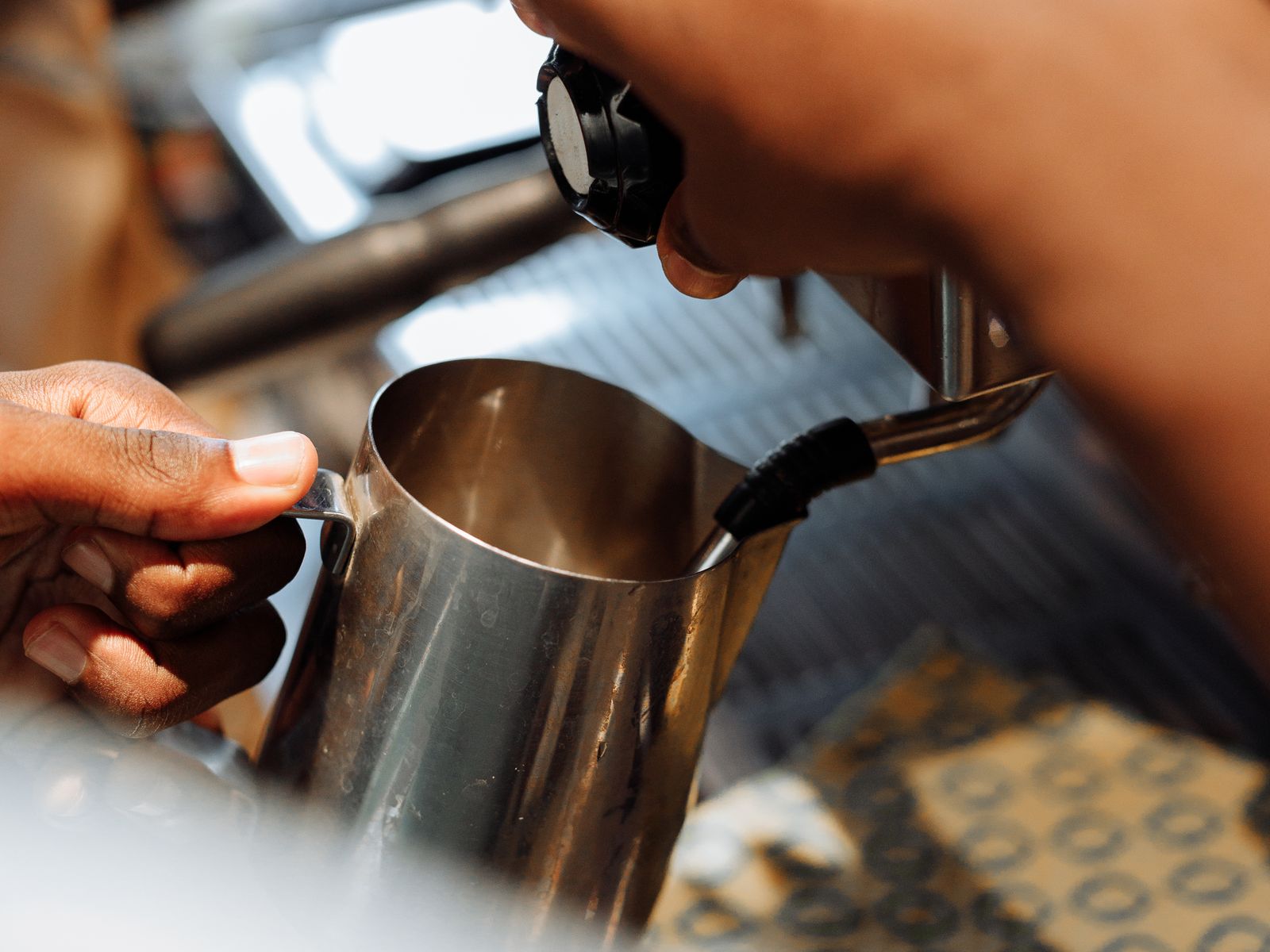 A steel milk pitcher you can fill with soapy water to practice latte art cheaply