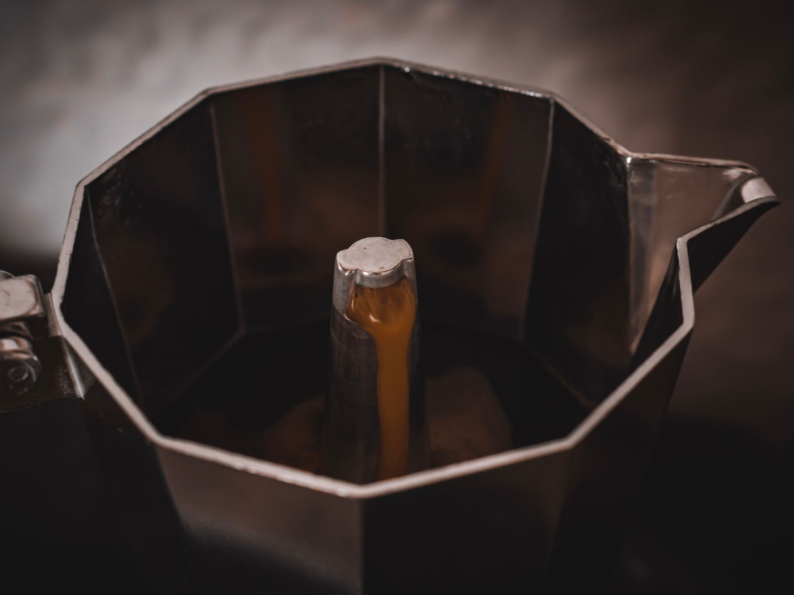 Brewing strong coffee in a moka pot for a homemade mocha
