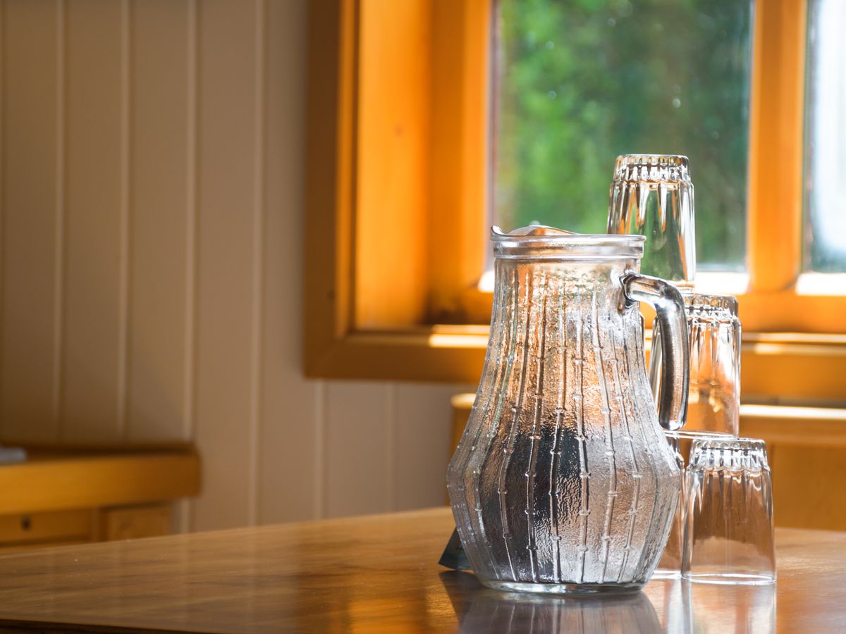 A glass jug of filtered water on a kitchen table